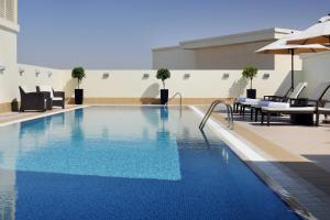 a large swimming pool in a hotel room at Avani Deira Dubai Hotel in Dubai