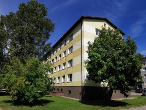 a building with a tree in front of it at Kesklinna silla apartment in Pärnu