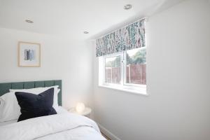 a bedroom with a bed and a window at Parkside House in Stevenage