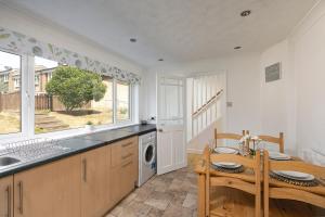 a kitchen with a table and a sink and a table and a kitchen with at Parkside House in Stevenage