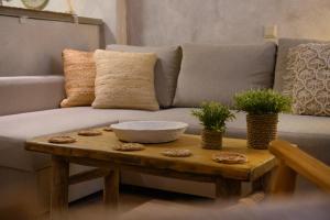 a living room with a couch and a wooden table at The In Town Apartment - With a Private Terrace in Corfu