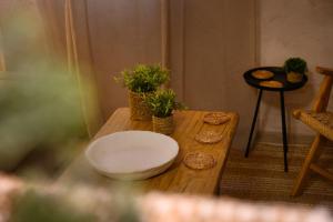 a wooden table with potted plants on top of it at The In Town Apartment - With a Private Terrace in Corfu