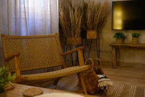 a living room with a chair and a television at The In Town Apartment - With a Private Terrace in Corfu