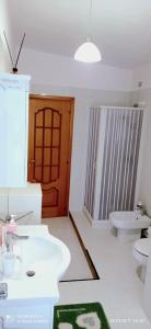 a bathroom with two sinks and a toilet and a door at Attiko 25 Residence - B&B - Alloggi Temporanei Isernia in Isernia