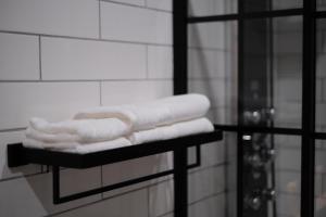a pile of towels on a shelf in a bathroom at Stunning exec spa retreat w/panoramic lake views! in Haslett