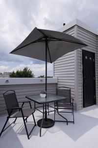 a table and two chairs and an umbrella on a patio at Montgomery condo in Philadelphia