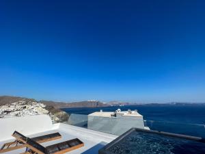 a view of the ocean from the balcony of a house at ArmonOia Suites Santorini in Oia +179 photos
