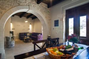 un soggiorno con tavolo e cesto di frutta di Villa Zefi a Elefterna