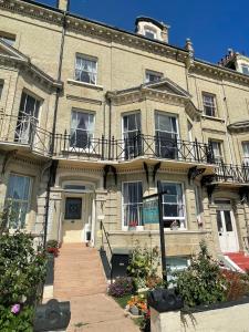 a large brick building with a staircase in front of it at Bon-Ami in Lowestoft