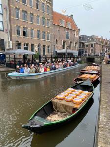 a group of people riding in boats on a river at Mini Apartment 30 m2 with in the hart of Alkmaar in Alkmaar