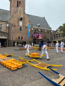 a group of people in white uniforms playing with yellow hoses at Mini Apartment 30 m2 with in the hart of Alkmaar in Alkmaar