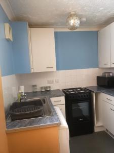 a kitchen with a sink and a stove at Spacious Entire Flat,1D in Great Yarmouth