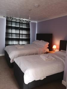 a bedroom with two beds and a window at Spacious Entire Flat,1D in Great Yarmouth