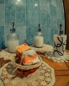 a bathroom with two bottles of soap and a basket of cheese at Raices Andinas in Tinogasta