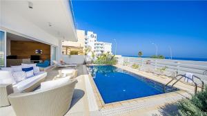 a house with a swimming pool on a balcony at Protaras Holiday Villa 100 in Protaras