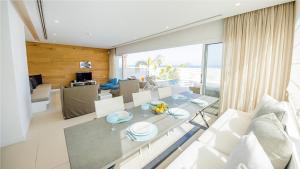 a dining room and living room with a table and chairs at Protaras Holiday Villa 100 in Protaras