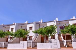 an apartment building with trees in front of it at TEPINSA · Alquiler de Apartamentos in Torreblanca