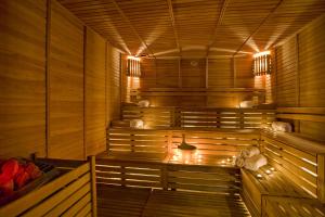 a wooden sauna with benches and lights in it at Best Western Plus Khan Hotel in Antalya