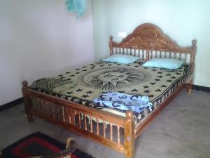 a bedroom with a bed with a wooden frame at Dolphinchilling in Alankuda +40 photos