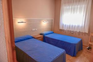 a room with two beds and a window at TEPINSA · Alquiler de Apartamentos in Torreblanca