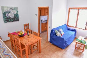 a living room with a table and a blue chair at TEPINSA · Alquiler de Apartamentos in Torreblanca