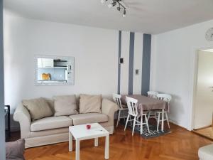 a living room with a couch and a table at Apartment in the city center in Varaždin +12 photos