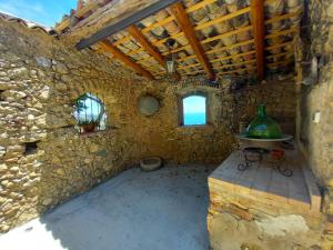 a room with a table in a stone building at Villa daniela in Taormina