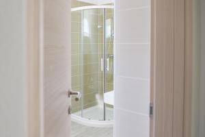 a bathroom with a shower and a glass door at Villa Danex Premium in Umag