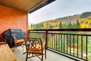 a balcony with two chairs and a table and a view at Luxury Ski In, Ski Out 3 Bedroom Mountain Residence In The Heart Of Lionshead Village With Heated Slope Side Pool And Hot Tub in Vail