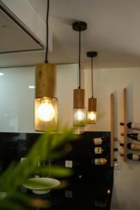 a room with three lights hanging from the ceiling at Casa de Campo Gracinda in Tourém