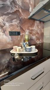 a counter with a tray of cups on it at My Zen Apartment (Κεντρικό, ήσυχο, πολλές παροχές) in Preveza +56 photos