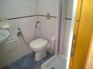 a small bathroom with a toilet and a sink at Il Gabbiano Blu - Monolocale Giallo in Marettimo