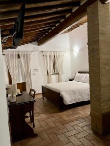 Postel nebo postele na pokoji v ubytování Agriturismo Le Querciole in Val d'Orcia