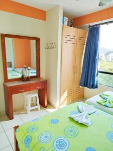 a bedroom with a mirror and a bed and a sink at Suites Marbensa, Malecón de Atacames in Atacames