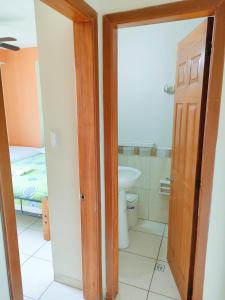 a bathroom with a toilet and a sink in a room at Suites Marbensa, Malecón de Atacames in Atacames