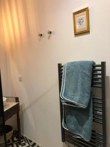 łazienka z dwoma ręcznikami wiszącymi na ścianie w obiekcie Le Gite de Tassigny w mieście Meursault