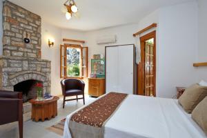 a bedroom with a large bed and a fireplace at Villa Vali in Akyaka