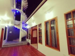 a hallway of a house with a spiral staircase at El Arco de Darwin in Puerto Ayora