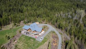 an aerial view of a large house in the woods at Little Black Bear Lodge/B&B in Bridge Lake