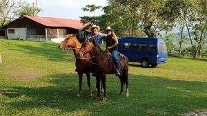 a man and a woman sitting on a horse at Cabañas Toniná Kayab in Ocosingo