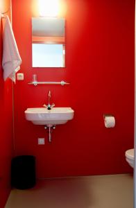 
a bathroom with a sink and a toilet at Blue Collar Hotel in Eindhoven
