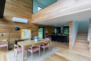 a dining room with wood paneling and a table and chairs at Sete Cidades Lake Cabin - Casa da Lagoa in Ponta Delgada
