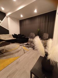 una sala de estar con 2 sillas y una mesa con plumas en Black Pearl Luxury Apartments, en Blackpool