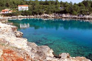 a large pool of water with people standing in it at Apartments by the sea Mudri Dolac, Hvar - 4042 in Vrbanj