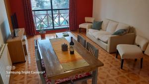 a living room with a table and a couch at Alojamiento Belgrano in San Carlos de Bariloche
