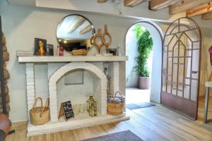 a room with a stone fireplace with a mirror at Agata Hotel Boutique & Spa in Mexico City