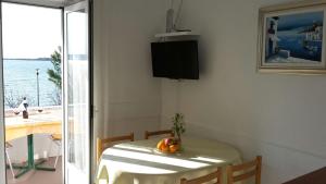 a room with a table with a fruit on it at Apartments and rooms by the sea Seline, Paklenica - 6440 in Starigrad-Paklenica