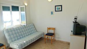 a living room with a couch and a tv at Apartments with a parking space Kozjaca, Paklenica - 6565 in Šibuljina