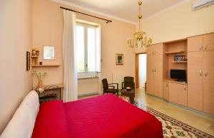 een slaapkamer met een rood bed en een woonkamer bij Balcone su Otranto in Otranto