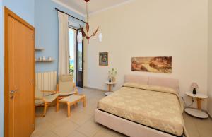 a bedroom with a bed and a table and a chair at Balcone su Otranto in Otranto